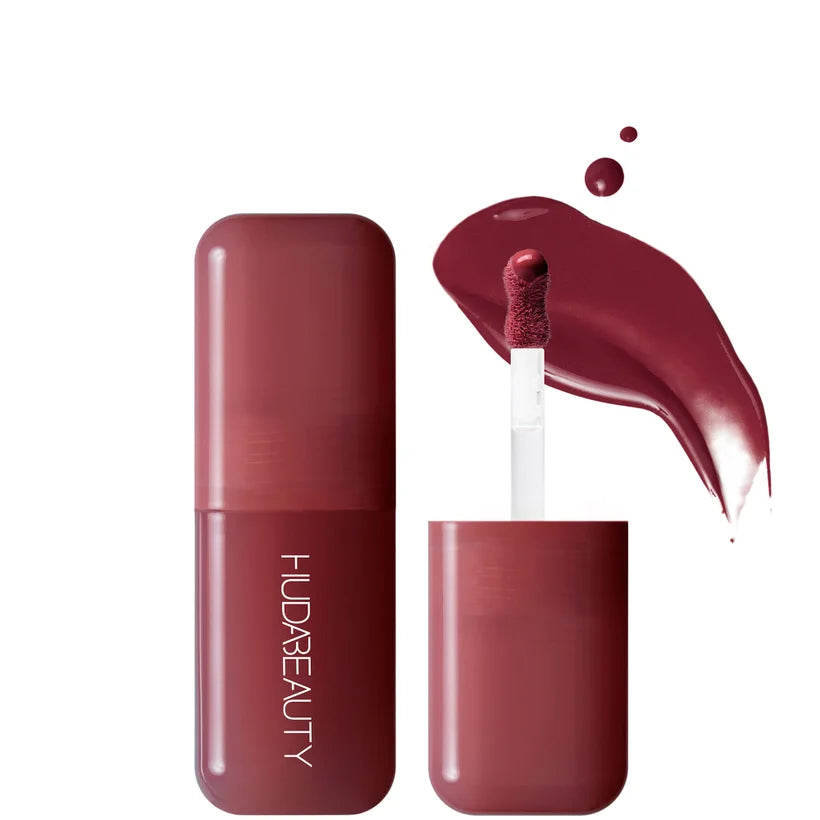 Huda Beauty Blush Filter Black Cherry, small glass bottle with burnt-berry liquid and a gold doe-foot applicator cap