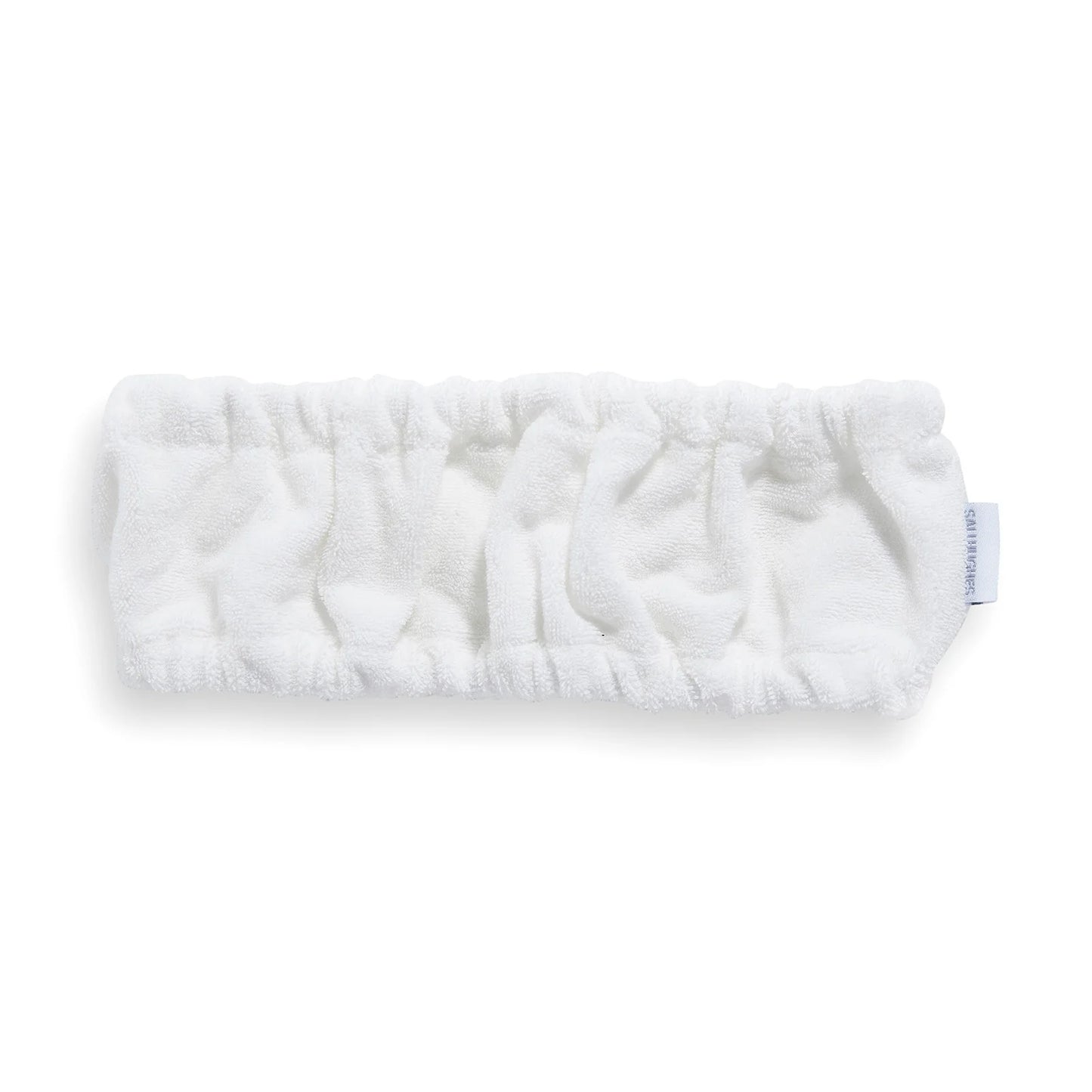 Revolution Sali Hughes Skincare Headband, soft white fabric headband with embroidered logo, designed to keep hair back during skincare or makeup routines