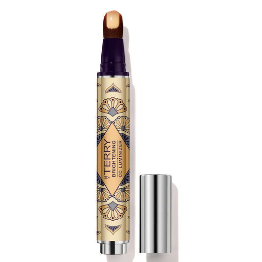 By Terry Brightening CC Luminizer, slim rose-gold pen-style applicator with brush tip, designed to highlight and illuminate the complexion