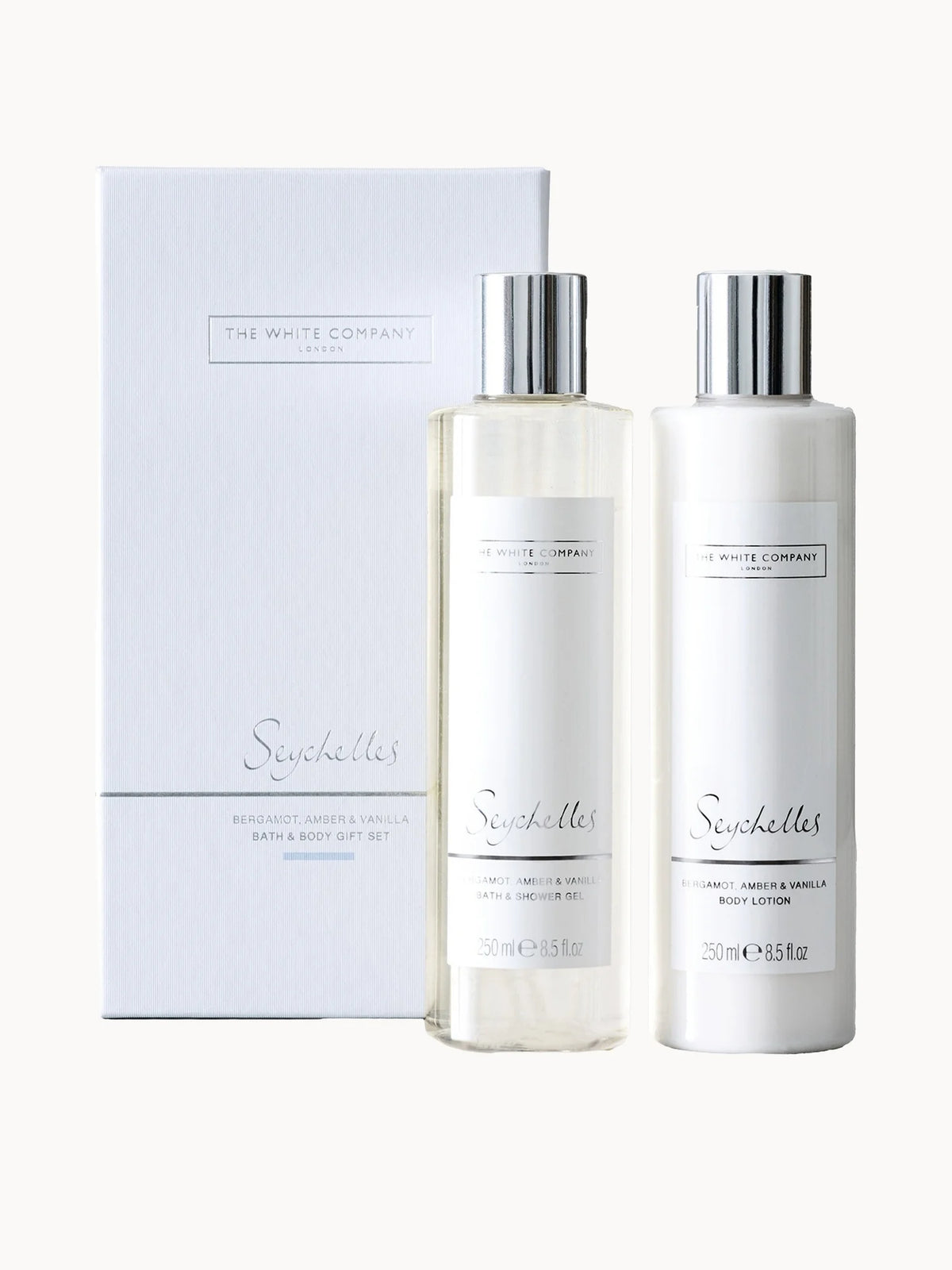 The White Company Seychelles Bath & Body Gift Set, white gift box with two cream-coloured bottles and gold Seychelles lettering
