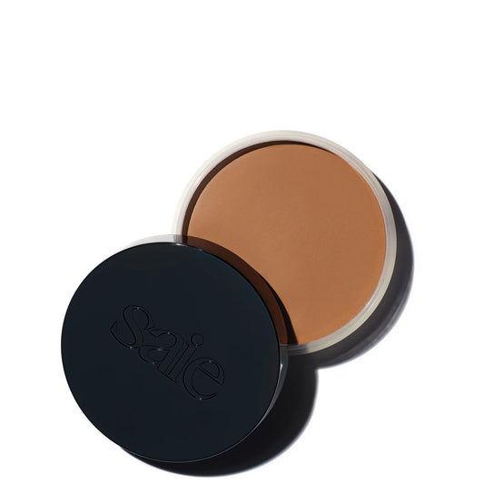 Saie Sun Melt Natural Cream Bronzer 30g - Medium Bronze, round cream bronzer compact with lid and printed Saie branding