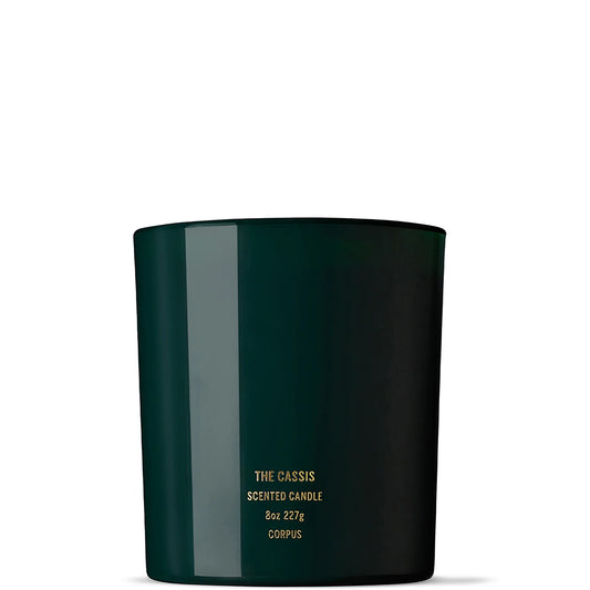 Corpus The Cassis soy wax candle in a minimalist glass jar with simple label, candle wax visible inside.