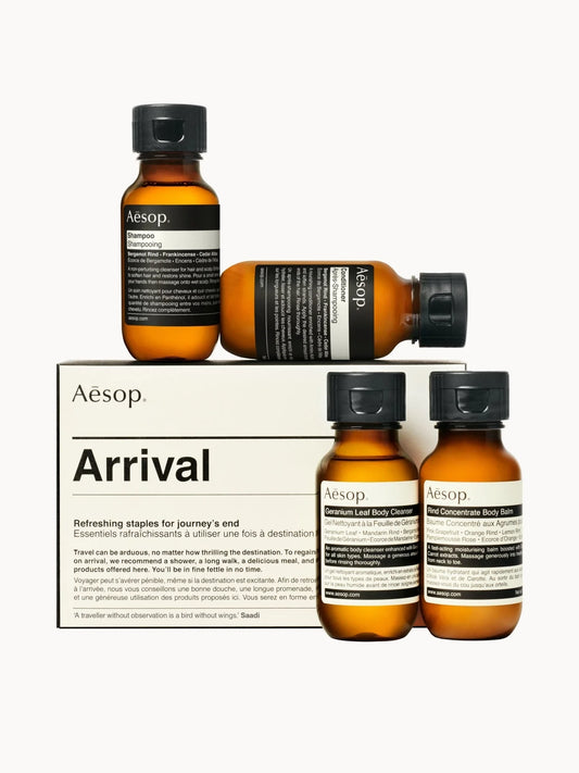 Aesop Arrival Travel Kit, four amber glass travel bottles with Aesop's minimal label design