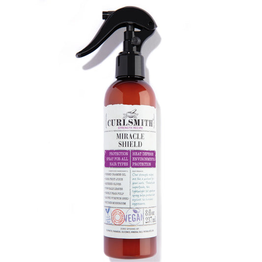 Curlsmith Miracle Shield 237ml, amber spray bottle with purple and beige label, designed to protect hair from heat, UV rays, and environmental damage