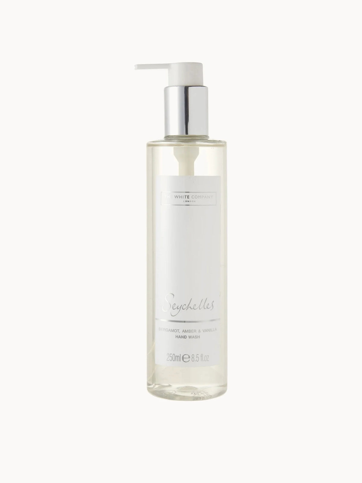 The White Company Seychelles Hand Wash 250ml, clear pump bottle with wooden-effect cap and The White Company Seychelles branding