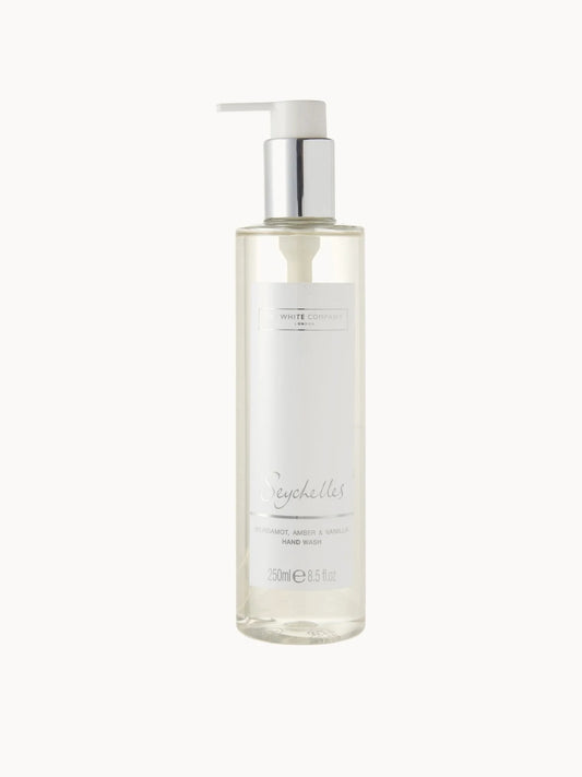 The White Company Seychelles Hand Wash 250ml, clear pump bottle with wooden-effect cap and The White Company Seychelles branding
