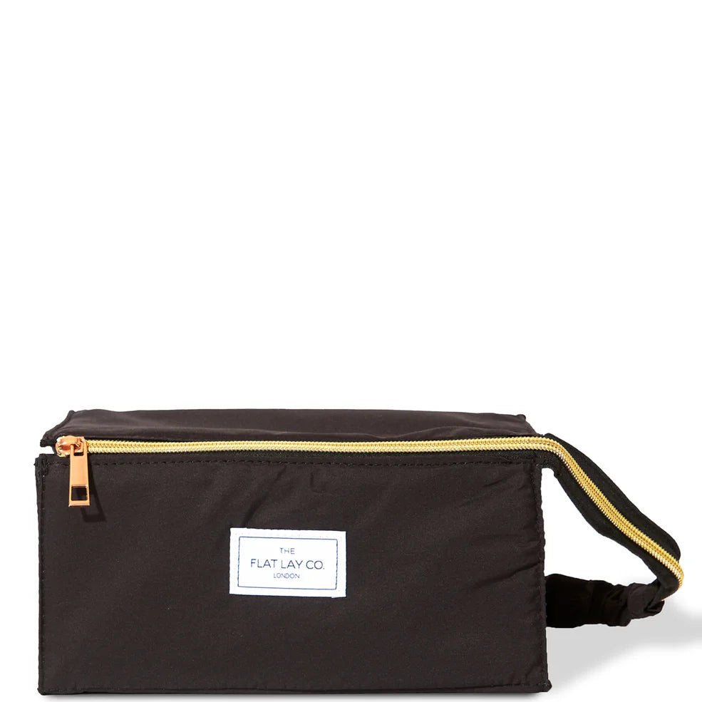 The Flat Lay Co. black travel bag with open-flat design