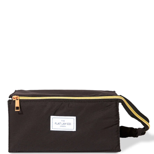 The Flat Lay Co. black travel bag with open-flat design