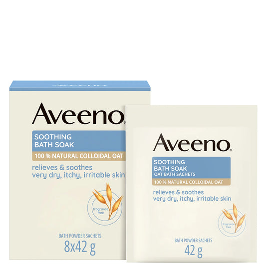 Aveeno soothing bath soak sachets dissolving into a milky bath for dry skin relief