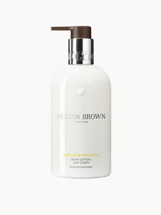 Molton Brown Orange and Bergamot Body Lotion 300ml in a tall orange-toned plastic bottle with a pump