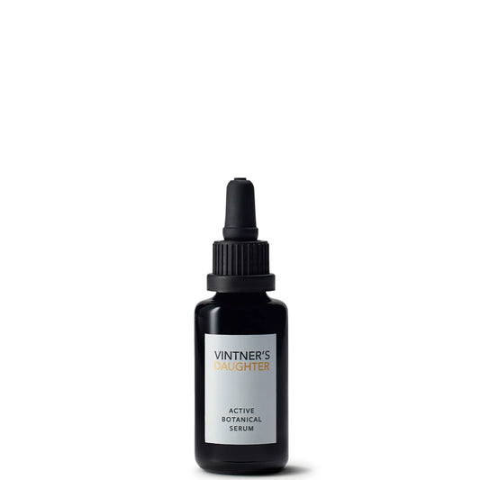 Travel-size botanical face serum in a small glass bottle, designed to nourish, brighten, and balance skin while helping improve the look of fine lines, pigmentation, and loss of elasticity.
