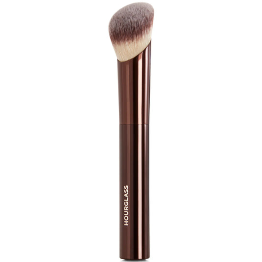 Hourglass Ambient Soft Glow Foundation Brush with tapered bristles and sleek metallic handle, shown laid flat.