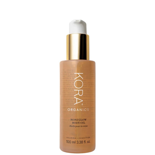 Kora Organics Noni Glow Body Oil 100ml clear bottle with green label and pump dispenser showing golden oil inside