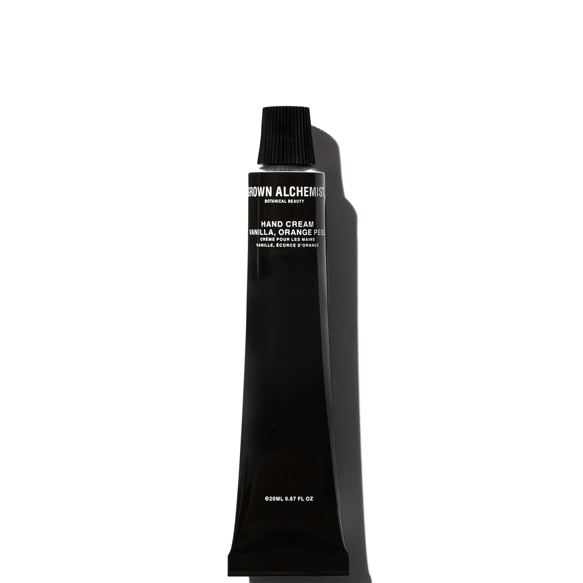 Grown Alchemist Restorative Hand Cream Vitamin E + Orange Peel 20ml, clear glass tube with a black pump dispenser and minimalist white label