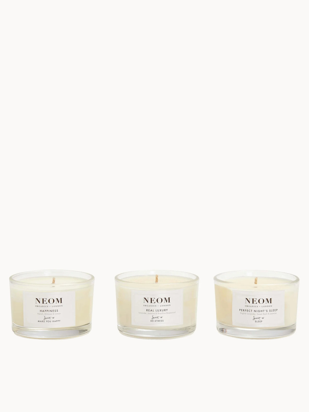 Neom Wellbeing Candle Trio, three mini glass candles with pastel labels