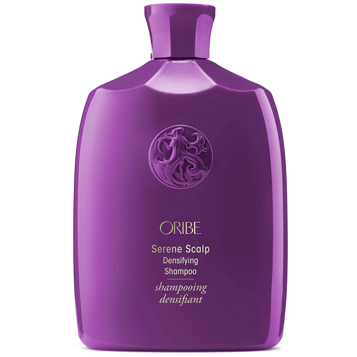 Oribe Serene Scalp Densifying Shampoo in a tall sculpted bottle, soft pastel tone with embossed Oribe logo near the cap.