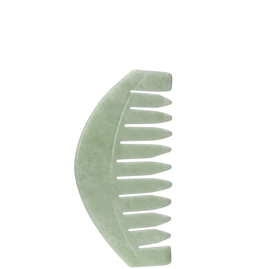 Act+Acre Scalp Gua Sha tool made from natural jade stone in minimal light green design made to stimulate circulation and support scalp health, placed beside a neutral-toned background.